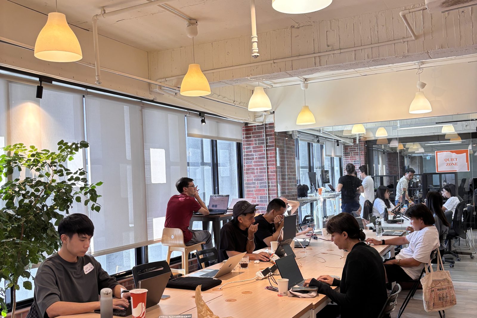 Members working at Day 1's open coworking floor